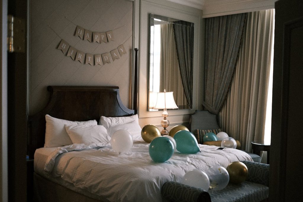 Elegant hotel room decorated with balloons and a Happy Birthday banner, creating a festive atmosphere.